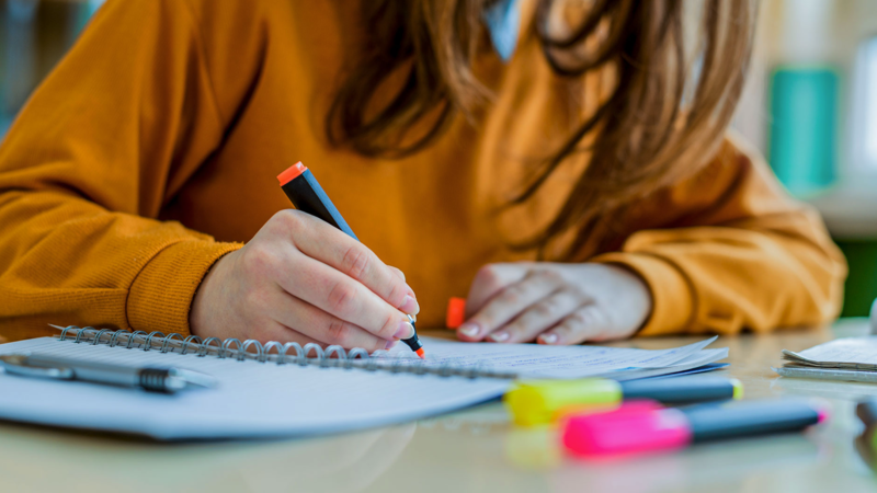 student highlighting a notebook
